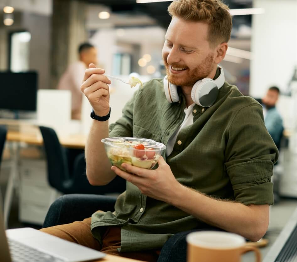 happy-businessman-eating-salad-on-lunch-break-in-t-2023-11-27-05-21-11-utc (1)