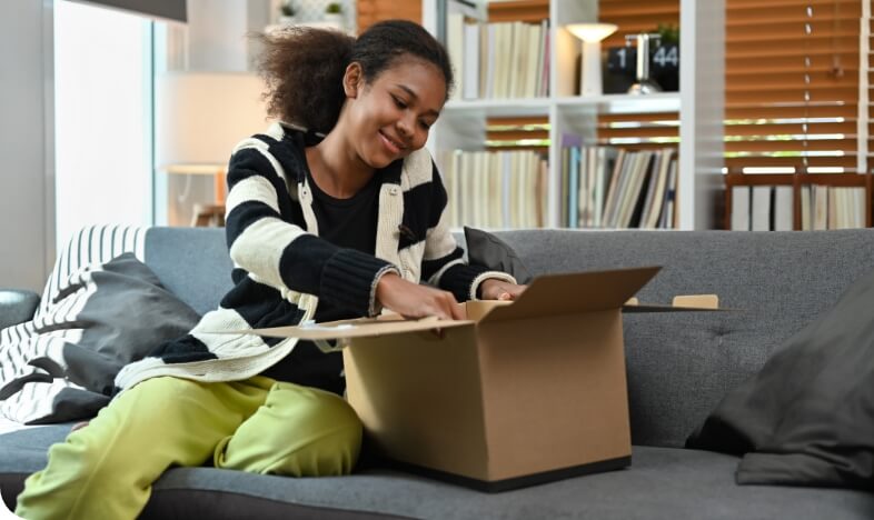 satisfied-young-african-american-woman-unpacking-d-2024-12-02-04-34-28-utc (3)