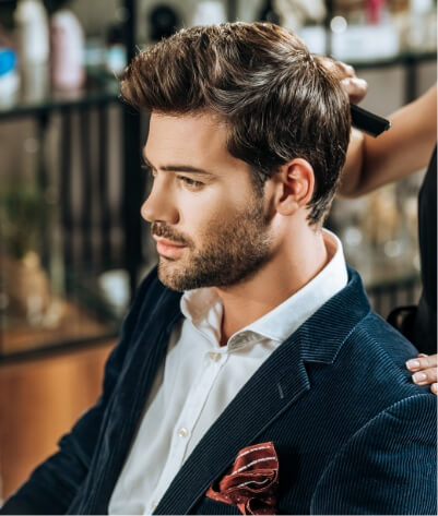 cropped-shot-of-hairstylist-combing-hair-to-handso-2023-11-27-05-23-52-utc (1)